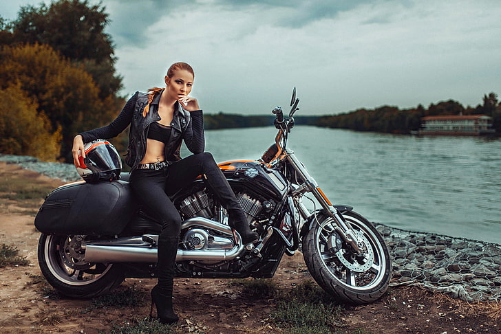 women's black leather zip-up biker jacket and black cruiser motorcycle