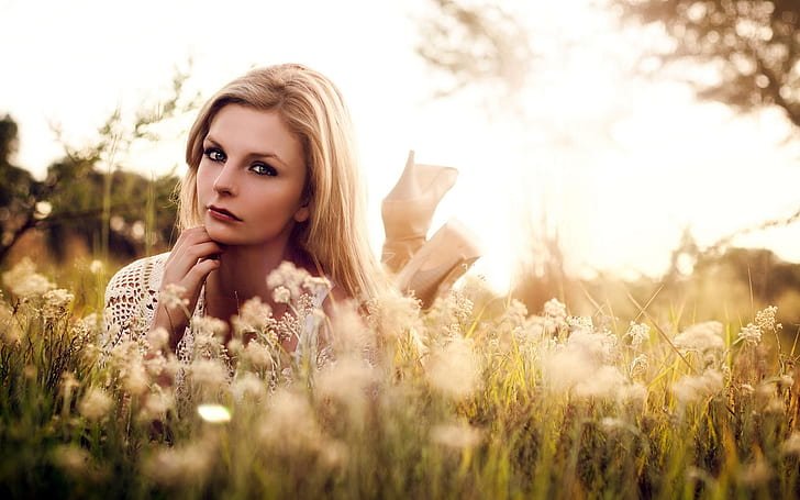 Blonde girl in grass, wildflowers, summer, sunshine