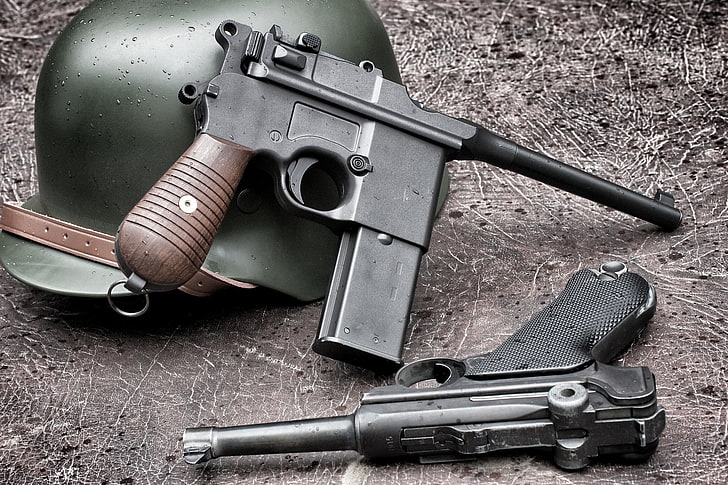 two vintage black pistols, guns, helmet, P08, Luger, Mauser C96