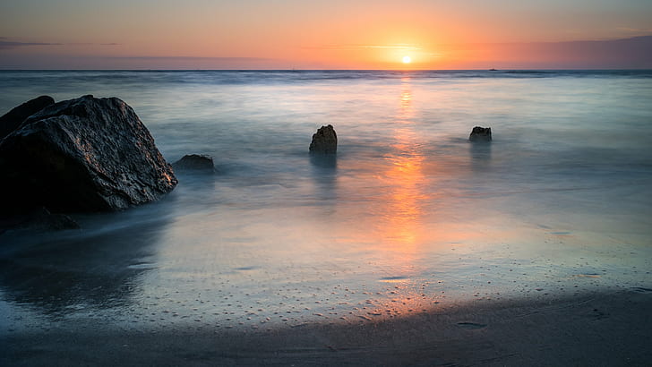 landscape photography of ocean with stone formations during golden hour, madeira beach, florida, madeira beach, florida
