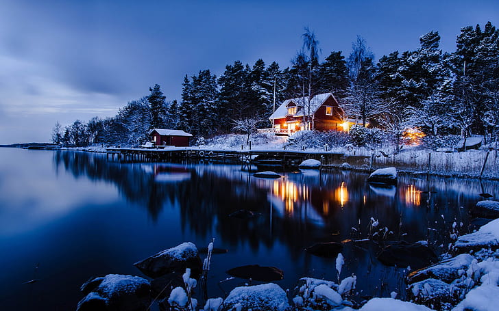 Stockholm, Sweden, winter landscape of snow, houses, lake, woods, blue style