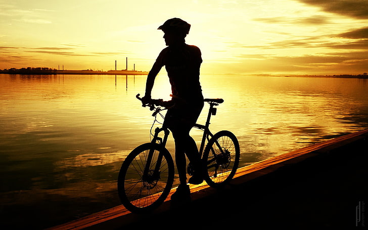 silhouette of man riding bike, sunlight, sport , bicycle, sunset