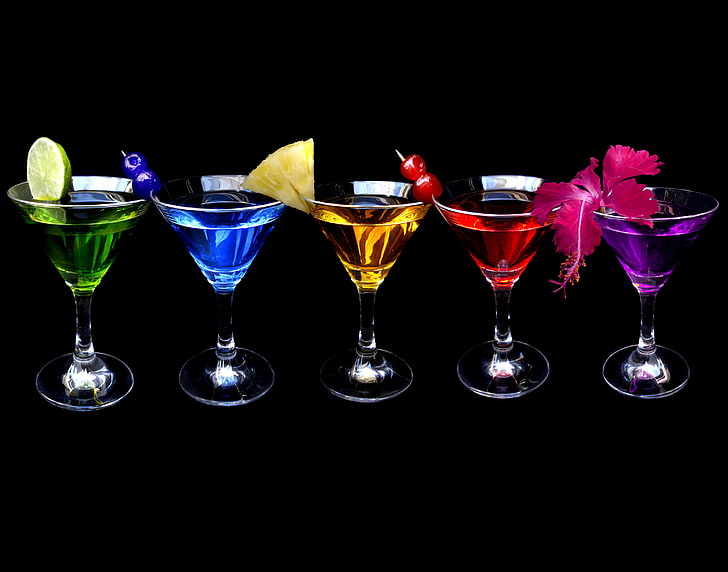 five clear martini glasses, flowers, black background, FRUIT