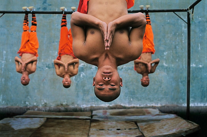 Monk hanging on steel bars, photography, China, monks, meditation