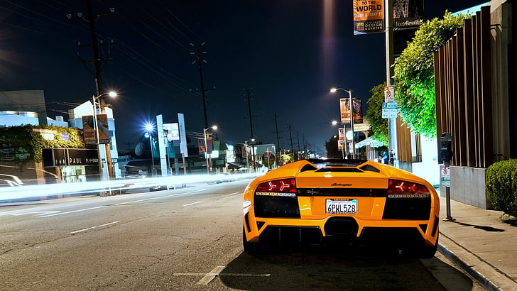 yellow Lamborghini Aventador sports coupe, orange sports car parked on side of road