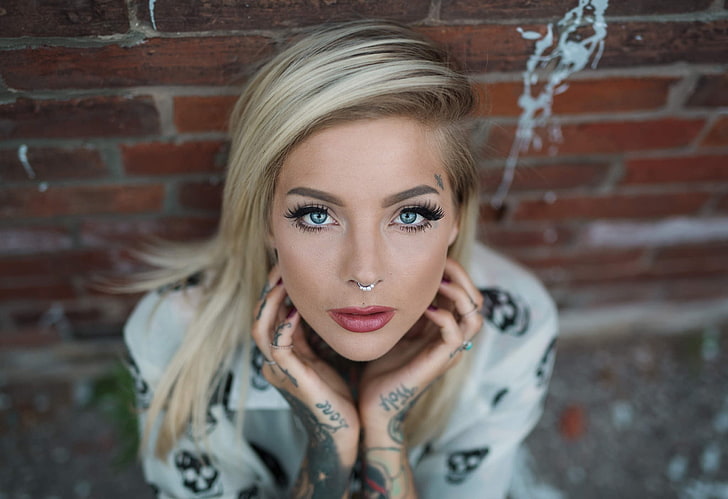 women, blonde, face, portrait, tattoo, nose rings, brick, brick wall