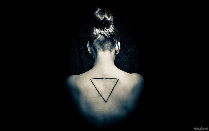 women's black triangle tattoo, one person, studio shot, indoors