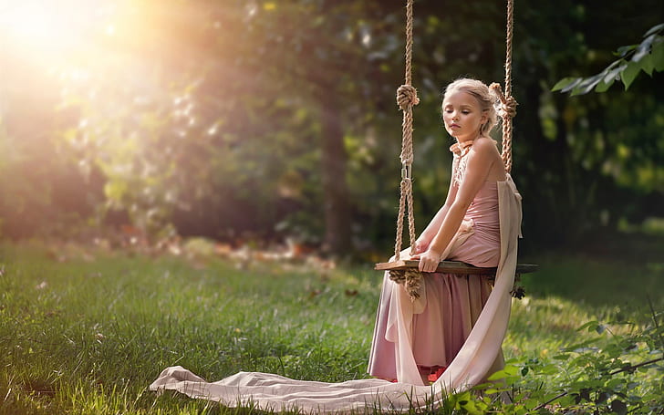 Cute girl sit on swing, sun, summer