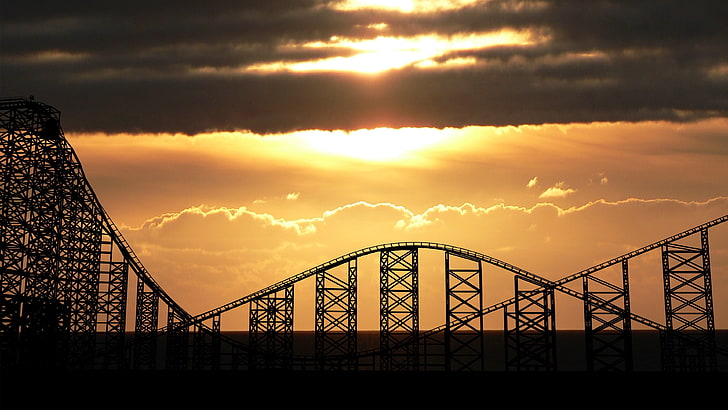silhouette of roller coaster during golden hour, UK, rollercoasters