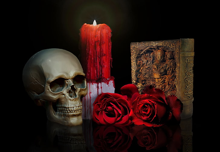 red pillar candle, two red roses and gray skull, book, human skeleton