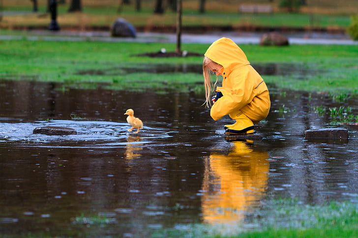 Girl and duck in raincoat, New York, spring, April