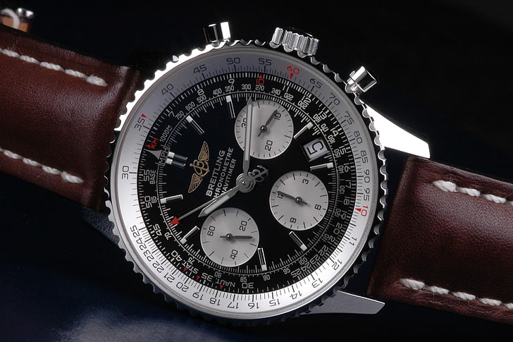 round silver chronograph watch with black leather strap, luxury watches