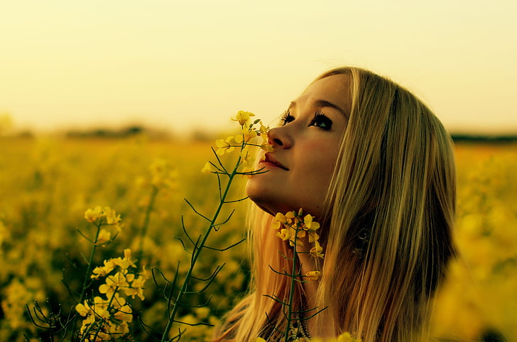 Rapeseed, women outdoors, blonde, yellow flowers, looking up