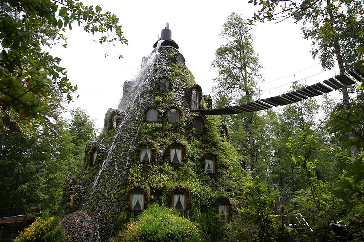 triangular-shaped house with waterfall and hanging bridge, nature