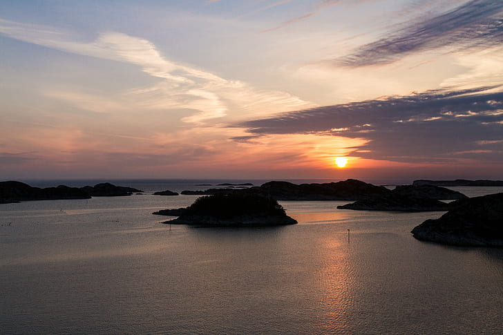 silhouette of island under sunset with clouds, Sotra, Norway