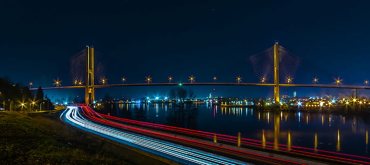 timelapse photography of vehicles traveling near suspension bridge during nighttime