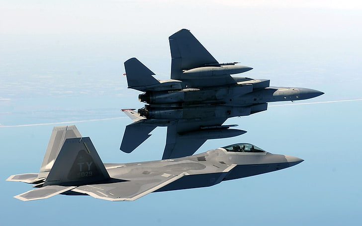 two gray fighter planes, F-22 Raptor, F-15 Eagle, military aircraft