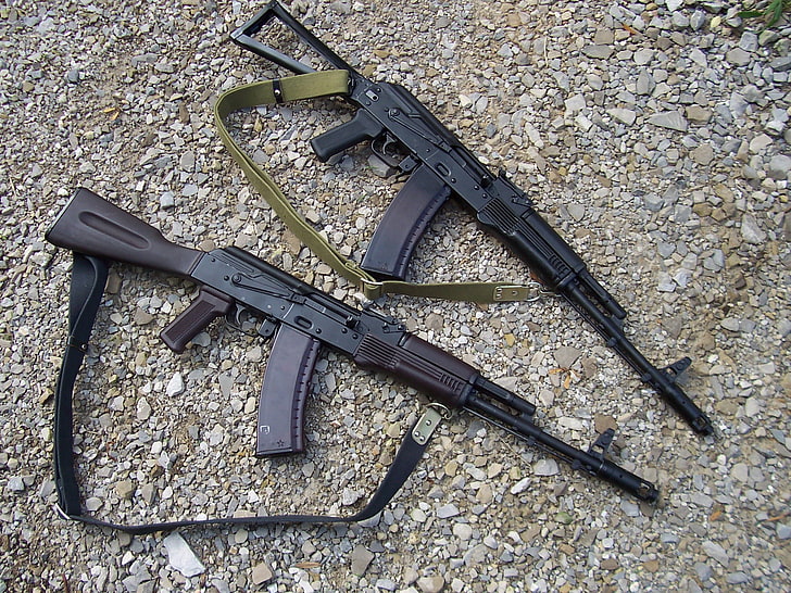 two black rifles, gravel, Kalash, 2 pieces, AK-74, Kalashnikovs