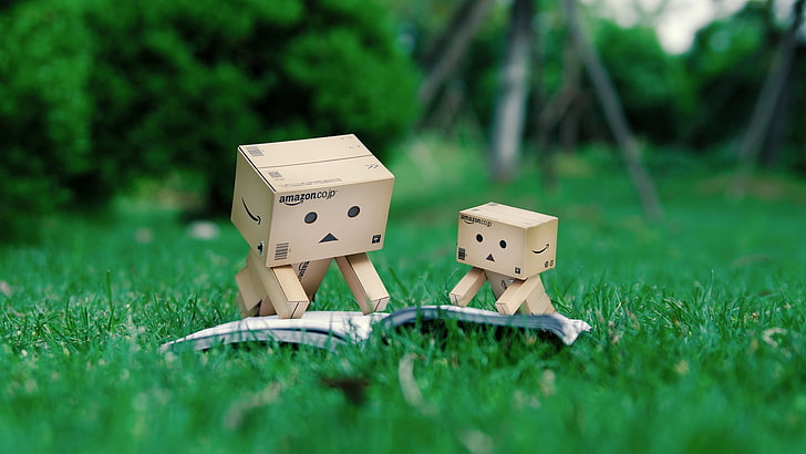 two brown wood box figurines, danboard, book, reading, cardboard robots