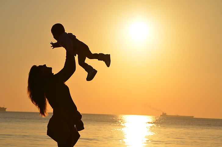 silhouette of woman carrying baby, mother, child, silhouettes