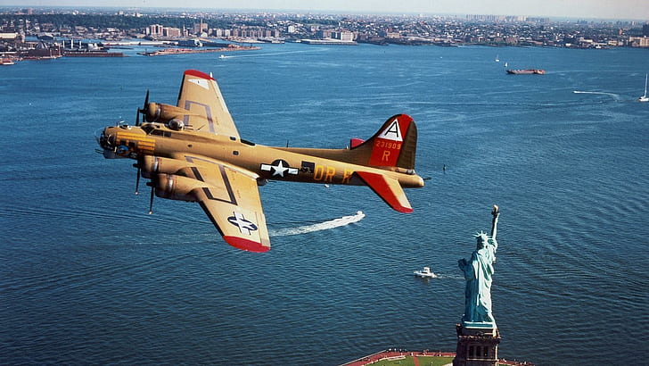 B17 Flying Fortress Over The Statue Of Liberty, beige-and-red jet plane