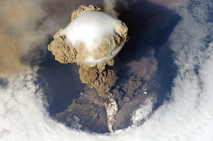 top of volcano, eruptions, aerial view, island, smoke, clouds