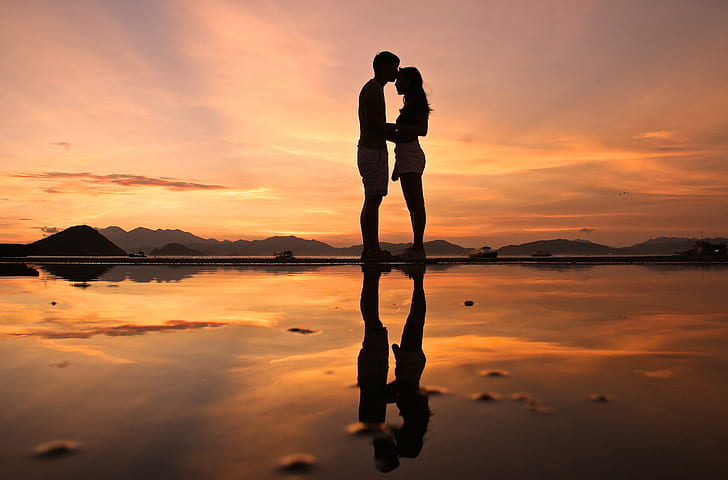 low angle silhouette photo of couple, sunset, burning love, Cargo