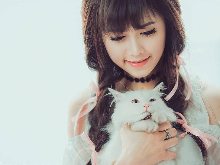 Smile Asian girl and white cat, white fur cat; white cold shoulder top