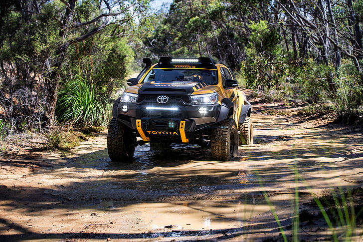 black and yellow Toyota off-road vehicle on muddy road, Toyota HiLux Tonka