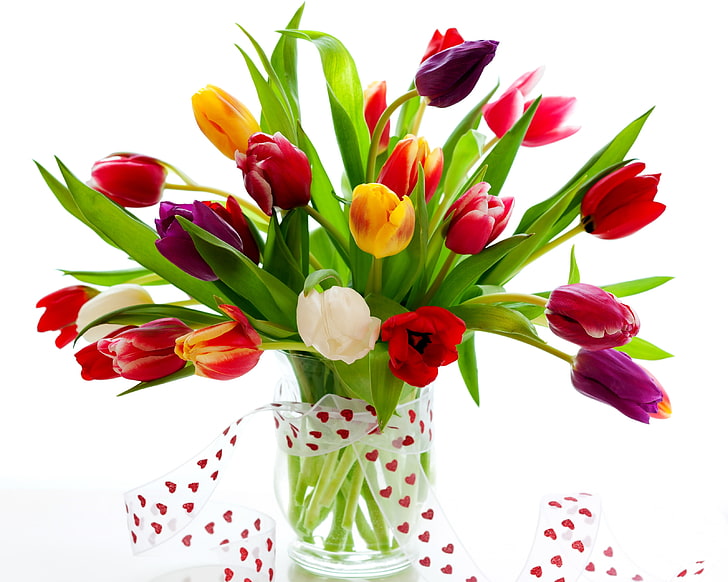 assorted-color tulips centerpiece, flowers, vase, ribbon, greenery