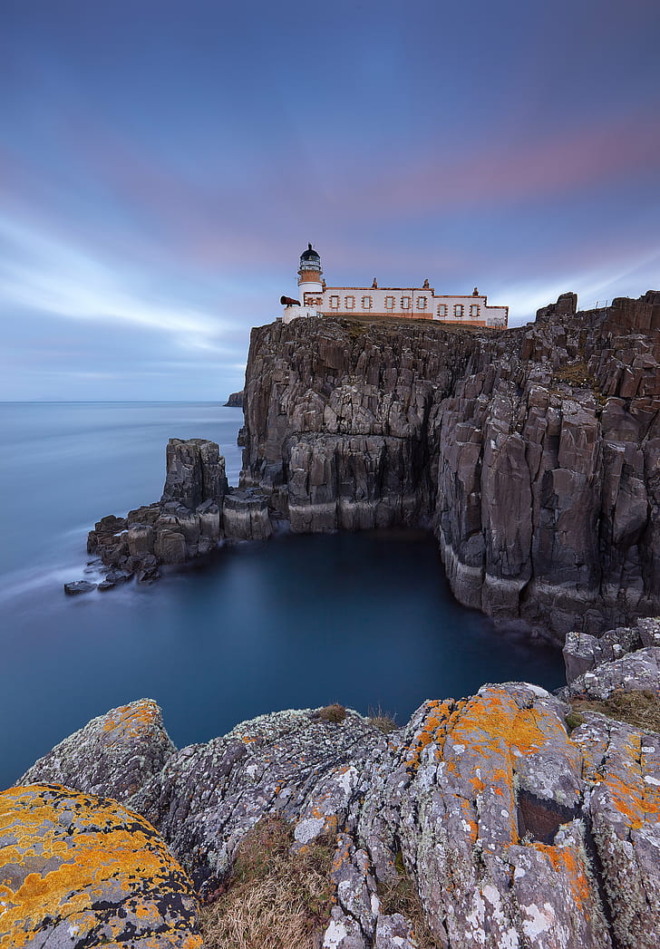 gamma photography of white and brown lighthouse on peak of rocky mountain during daytime, neist point, skye, scotland, neist point, skye, scotland