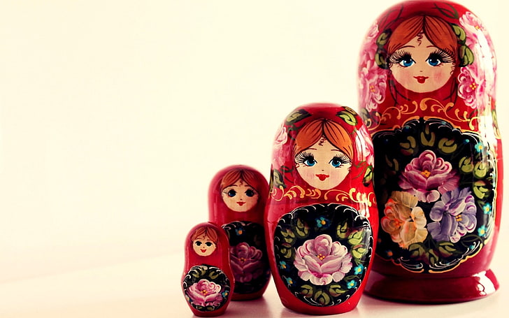 four red-and-multicolored floral ceramic matryoskha dolls, souvenir