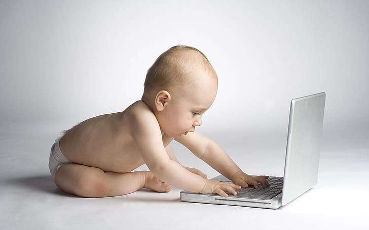 Cute baby learning with laptop computer