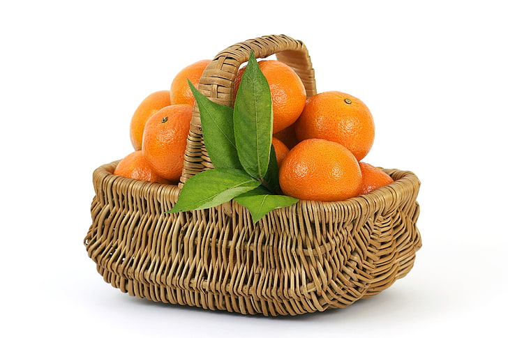 brown wicker basket and bundle of oranges, fruit, leaves, citrus Fruit