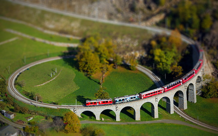 tilt shift photography of trains passing on railway, red train on track miniature, HD wallpaper