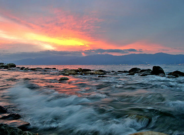 photo of tidal wave in body of water sea during sunset, reggio, reggio