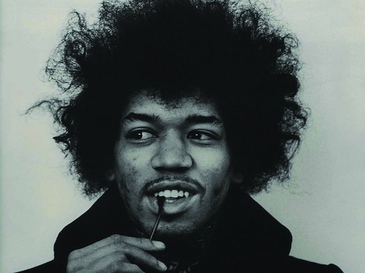 grayscale portrait photo of Jimi Hendrix, virtuoso guitarist