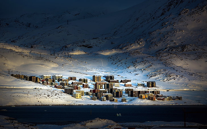 aerial photo of village on the foot of snowy mountain, Greenland