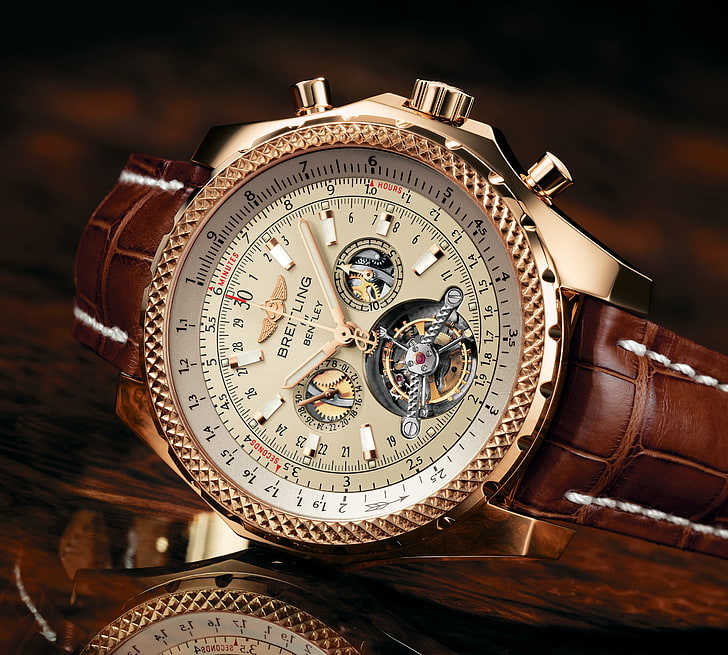 round gold-colored Bretling chronograph watch with brown strap