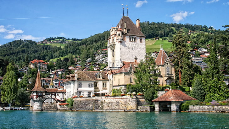 white castle with brown bricked roof, castle oberhofen, switzerland
