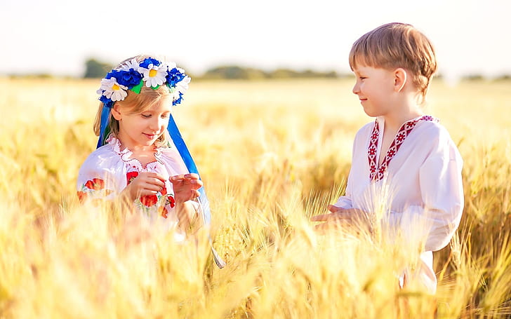 Ukraine, children, boy, girl, wheat field, girl's blue,white flower headdress; boy's white v-neck long sleeve shirt