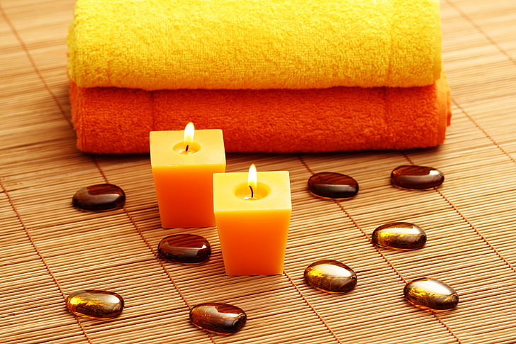 two yellow candles, stones, towels, Spa, Mat, spa Treatment, aromatherapy