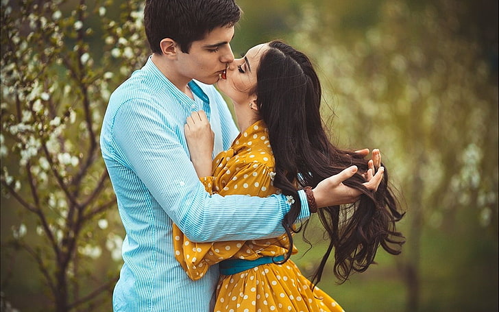 Couple Mood Love Kiss, men's pinstriped teal dress and shirt and women's orange and white polka-dot long-sleeved dress