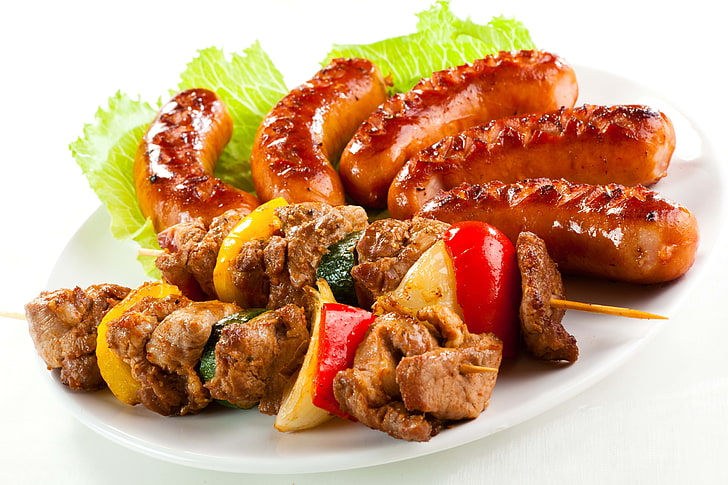 four fried sausages, kebabs, cabbage, plate, white background