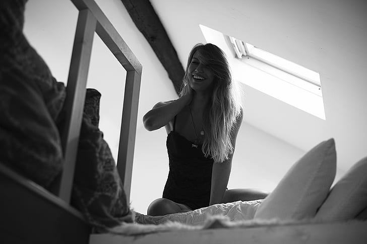 women, monochrome, in bed, smiling