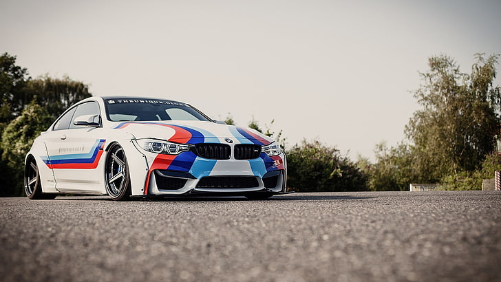 close up photograph of white, red, and blue BMW coupe, BMW M4
