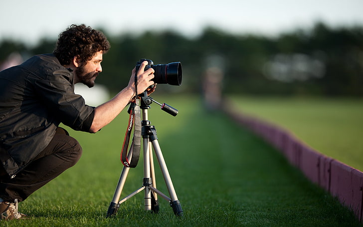 black DSLR camera with gray tripod stand, hair, beard, situation