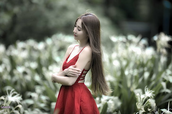 selective photography of brown haired woman wearing red spaghetti strap dress