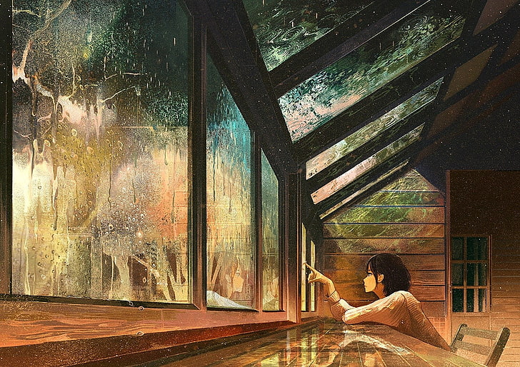 woman sitting on chair while looking to glass window artwork