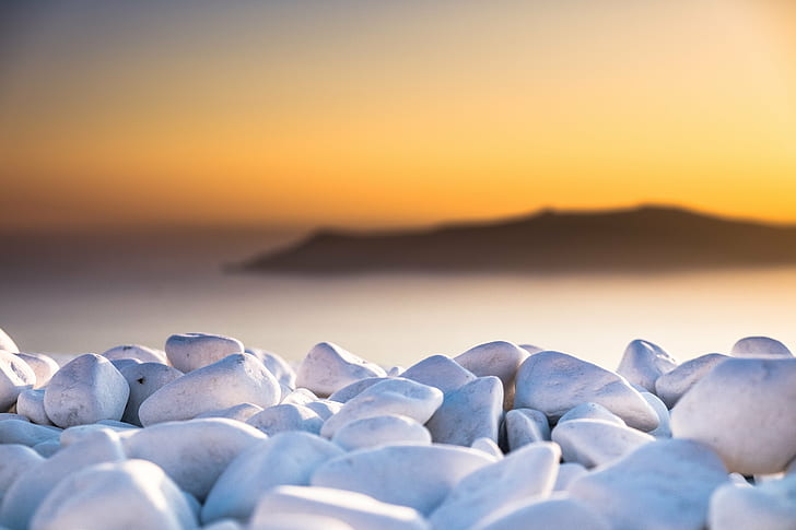 selective focus photo of bunch of white pebbles, white light